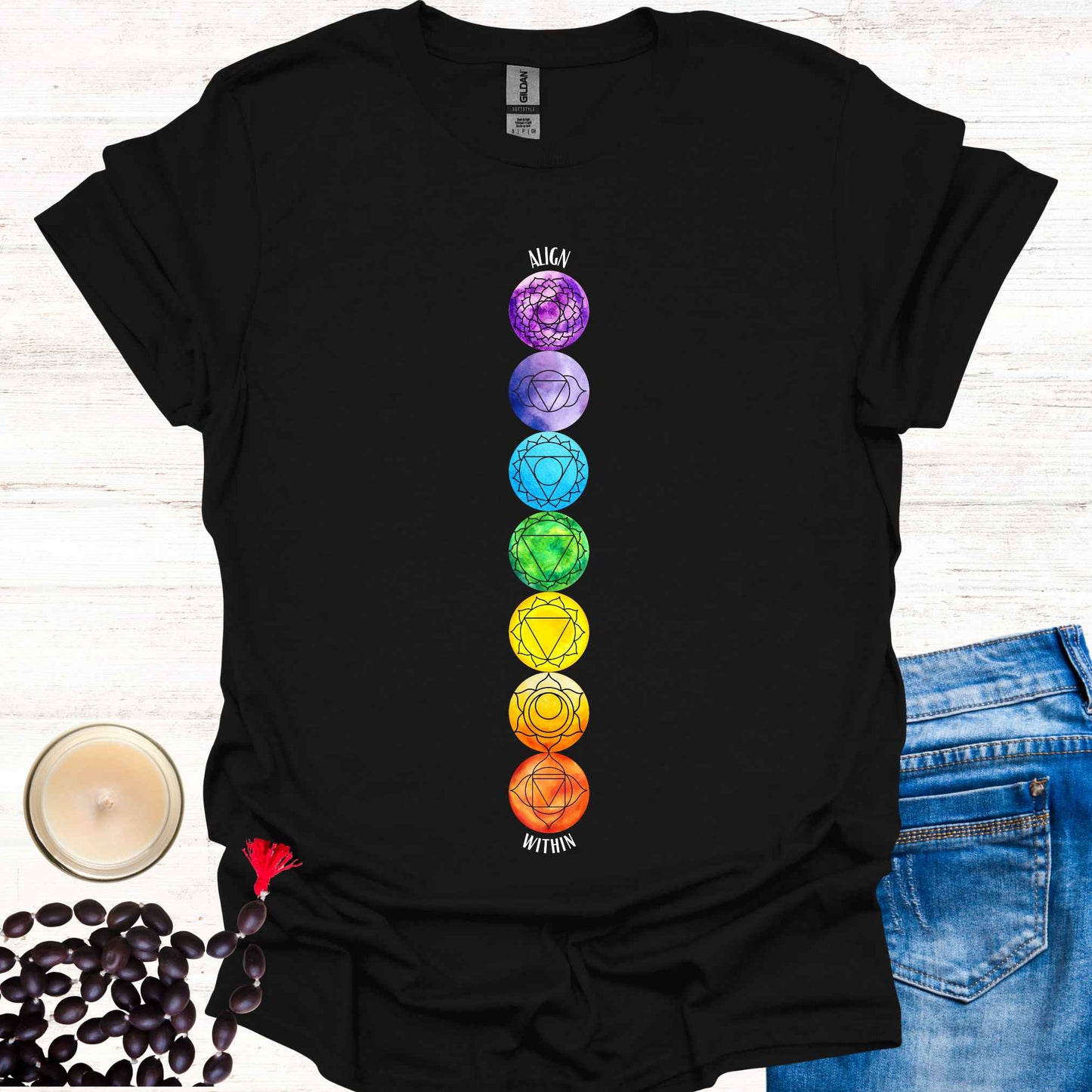 Black t-shirt featuring a colourful, vibrant design of the 7 chakras aligned vertically, each with its corresponding mandala symbol, accompanied by the phrase 'Align Within'. This design represents the energy centers within the body and emphasizes the importance of inner balance and harmony. Rooted in ancient wisdom, it inspires mindfulness, meditation, and self-reflection, aligning with themes of spiritual awakening and holistic well-being. Perfect for yoga practitioners and seekers of wisdom.