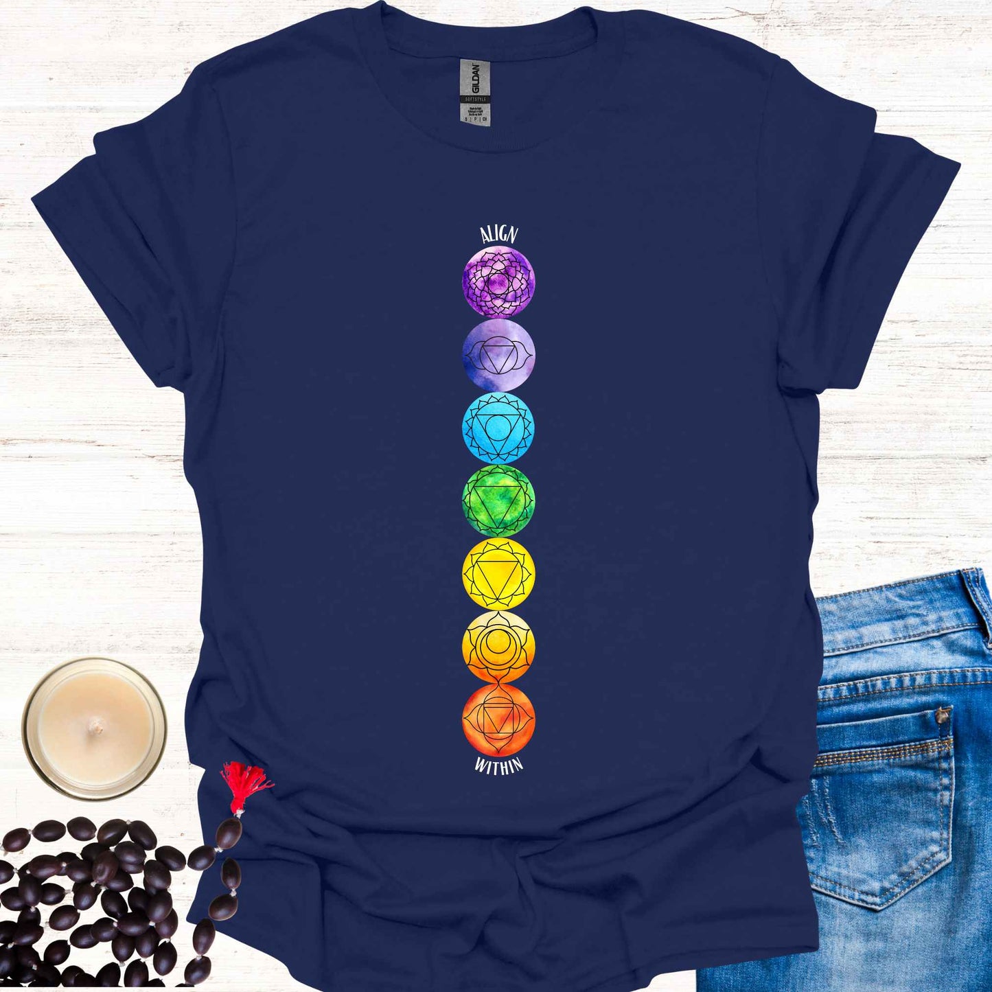 Navy blue t-shirt featuring a colourful, vibrant design of the 7 chakras aligned vertically, each with its corresponding mandala symbol, accompanied by the phrase 'Align Within'. This design represents the energy centers within the body and emphasizes the importance of inner balance and harmony. Rooted in ancient wisdom, it inspires mindfulness, meditation, and self-reflection, aligning with themes of spiritual awakening and holistic well-being. Perfect for yoga practitioners and seekers of wisdom.