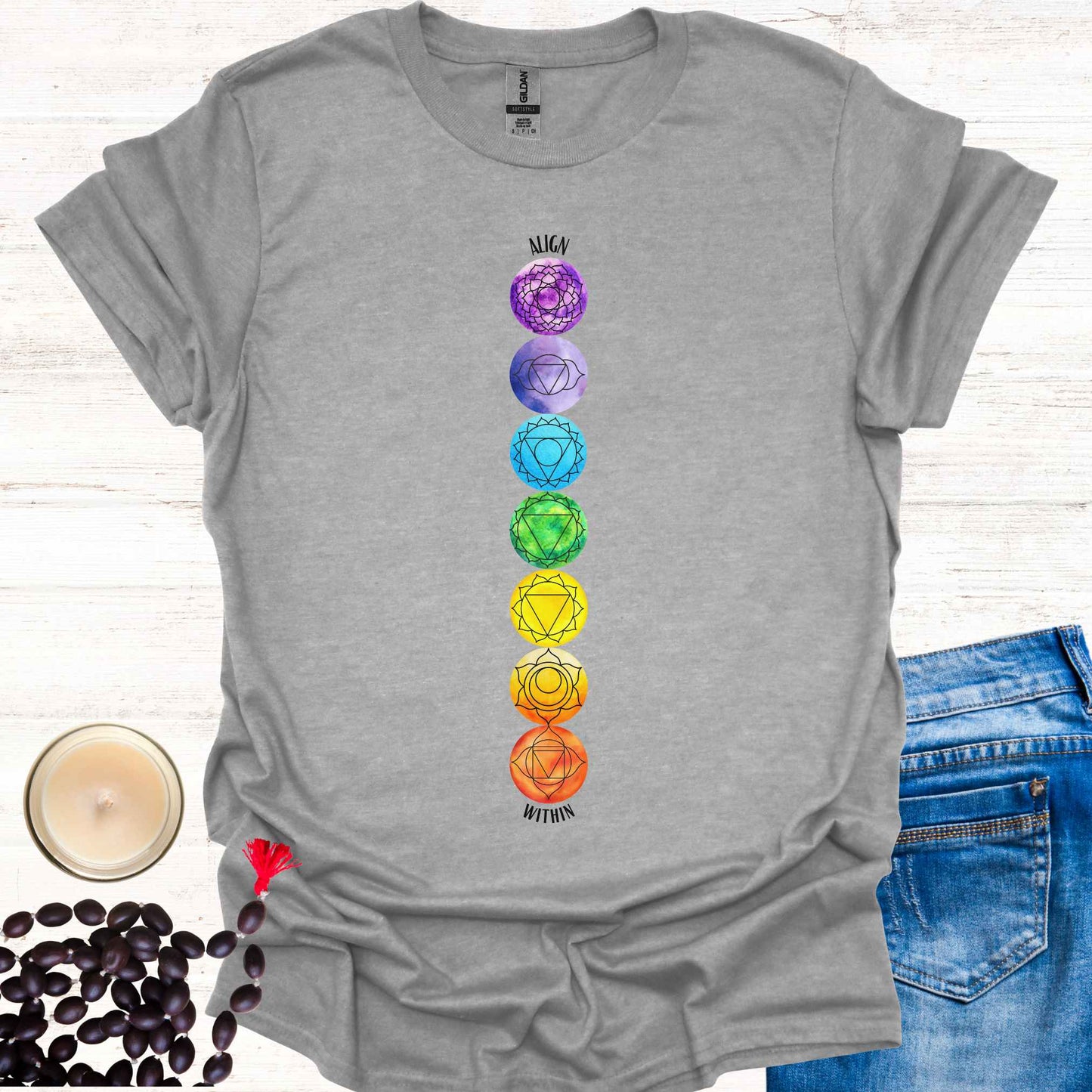 Grey t-shirt featuring a colourful, vibrant design of the 7 chakras aligned vertically, each with its corresponding mandala symbol, accompanied by the phrase 'Align Within'. This design represents the energy centers within the body and emphasizes the importance of inner balance and harmony. Rooted in ancient wisdom, it inspires mindfulness, meditation, and self-reflection, aligning with themes of spiritual awakening and holistic well-being. Perfect for yoga practitioners and seekers of wisdom.