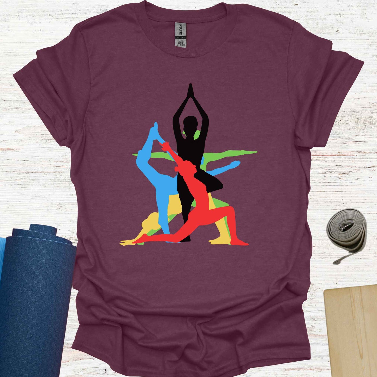 Purple t-shirt featuring a vibrant graphic of a human form in various overlapping yoga asanas, rendered in different colors. This design captures the fluidity and diversity of yoga, making it a perfect fit for yoga lovers and practitioners who embrace movement, mindfulness, and inner balance.