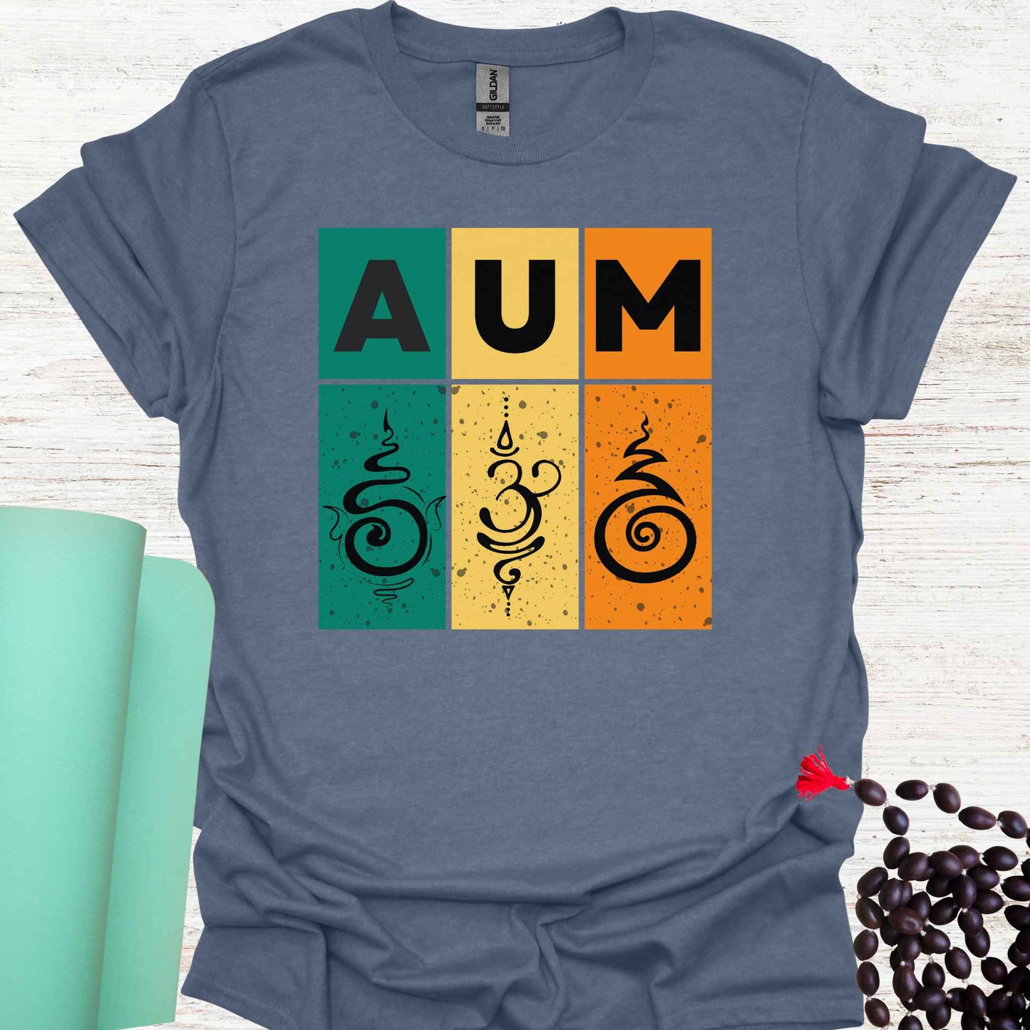 Blue t-shirt with retro sunset-style design with green, yellow, and red bars, bold 'AUM' text, and Sanskrit symbols. Represents the sacred sound AUM, unity, and spiritual essence. The retro aesthetic merges timeless spirituality with modern design, appealing to those who practice meditation, yoga, or seek deeper spiritual awareness.