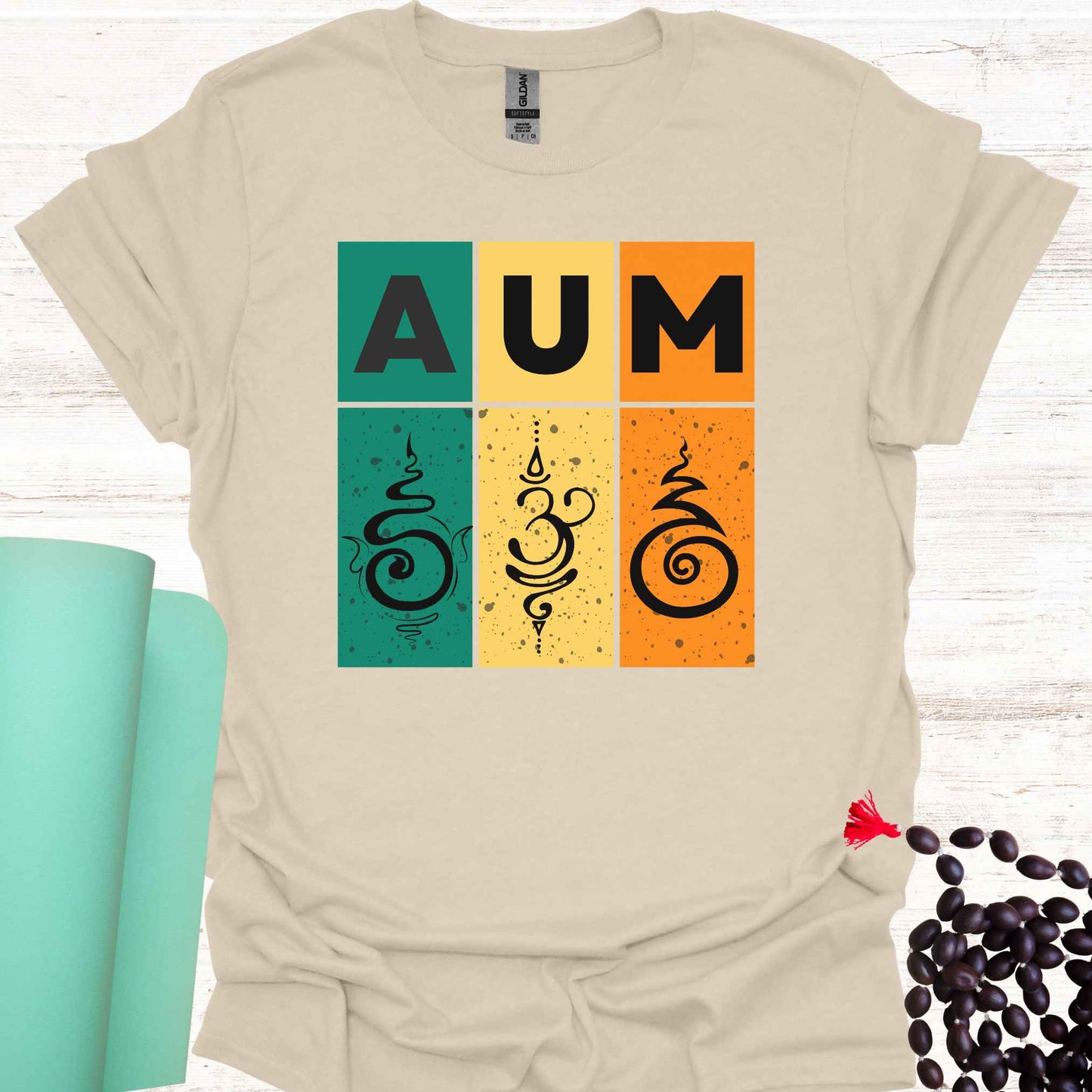 Natural t-shirt with retro sunset-style design with green, yellow, and red bars, bold 'AUM' text, and Sanskrit symbols. Represents the sacred sound AUM, unity, and spiritual essence. The retro aesthetic merges timeless spirituality with modern design, appealing to those who practice meditation, yoga, or seek deeper spiritual awareness.