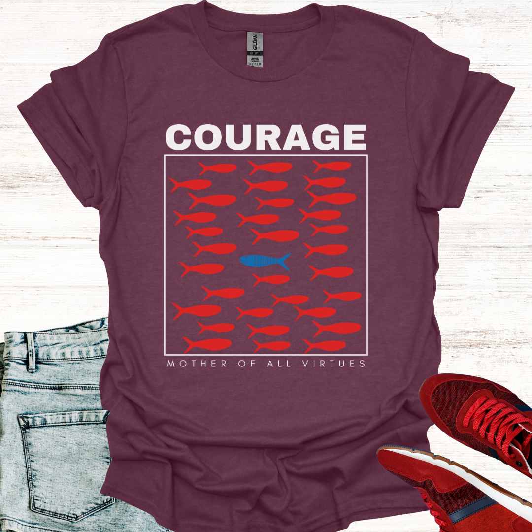 Maroon purple t-shirt featuring a design of red fish swimming, with a sole blue fish swimming against the current, symbolizing individuality, perseverance, and the courage to defy societal norms. It is accompanied by the phrase: Courage: Mother of All Virtues. This design is a powerful representation of strength in following your own unique path, even when it means going against the flow. Perfect for those who value independence, resilience, and self-discovery.