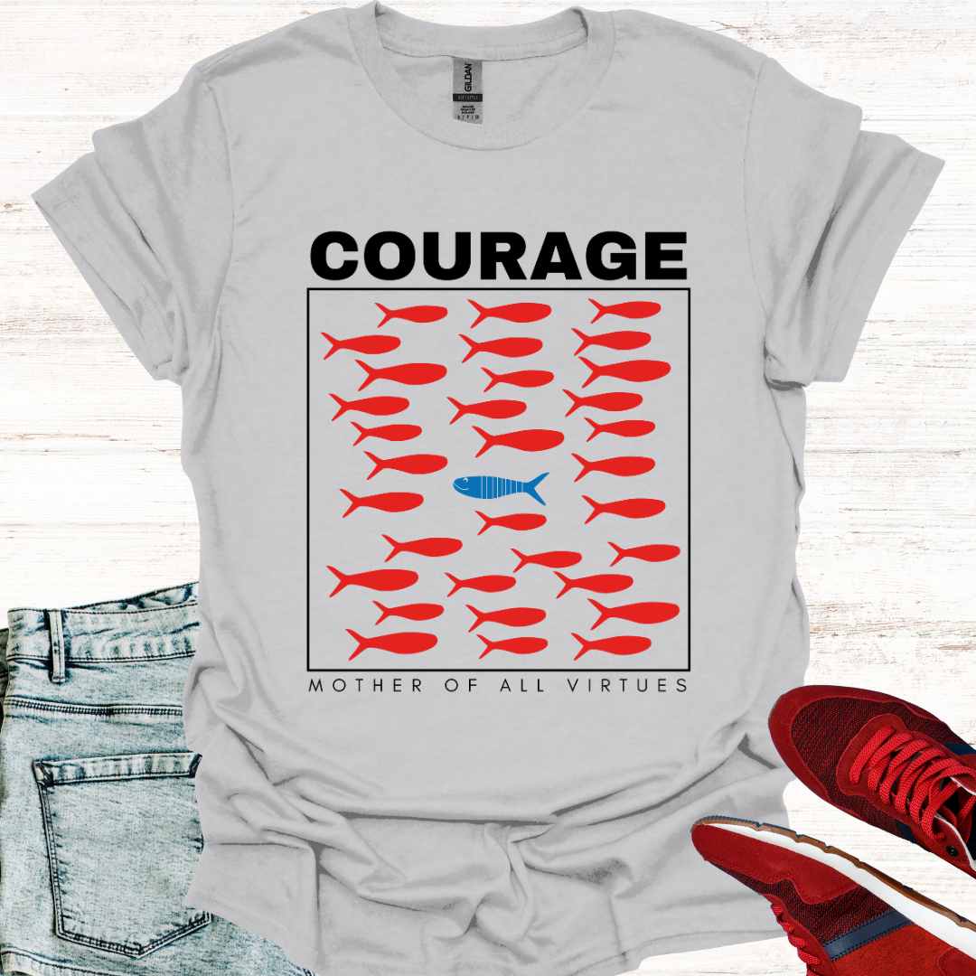 Grey t-shirt featuring a design of red fish swimming, with a sole blue fish swimming against the current, symbolizing individuality, perseverance, and the courage to defy societal norms. It is accompanied by the phrase: Courage: Mother of All Virtues. This design is a powerful representation of strength in following your own unique path, even when it means going against the flow. Perfect for those who value independence, resilience, and self-discovery.