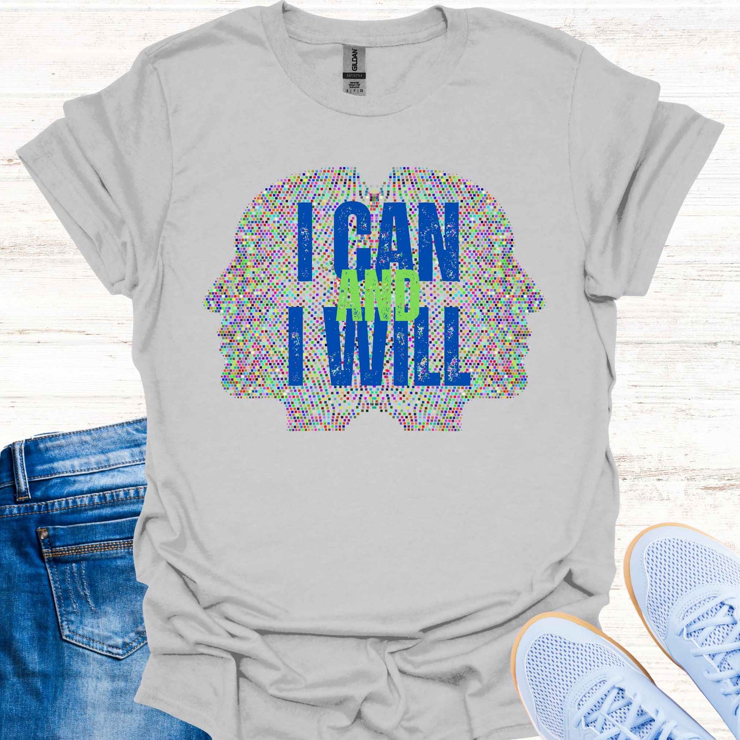 Grey t-shirt featuring a graphic of two side profiles of faces composed of many small dots, accompanied by the empowering phrase 'I Can and I Will.' This design inspires confidence, positivity, and self-belief, encouraging wearers to overcome challenges and embrace determination. Perfect for individuals seeking motivation and a reminder of their inner strength.
