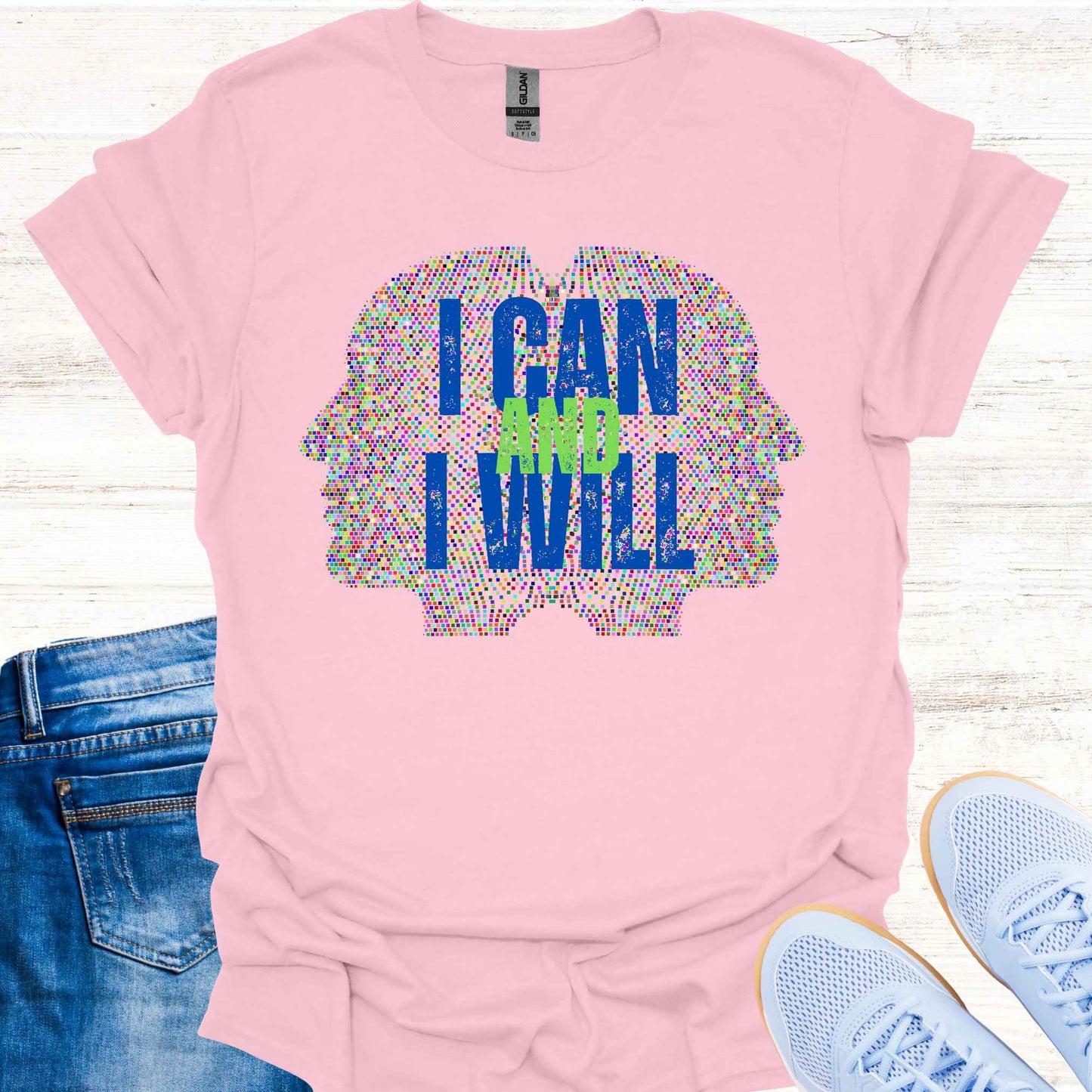 Light pink t-shirt featuring a graphic of two side profiles of faces composed of many small dots, accompanied by the empowering phrase 'I Can and I Will.' This design inspires confidence, positivity, and self-belief, encouraging wearers to overcome challenges and embrace determination. Perfect for individuals seeking motivation and a reminder of their inner strength.