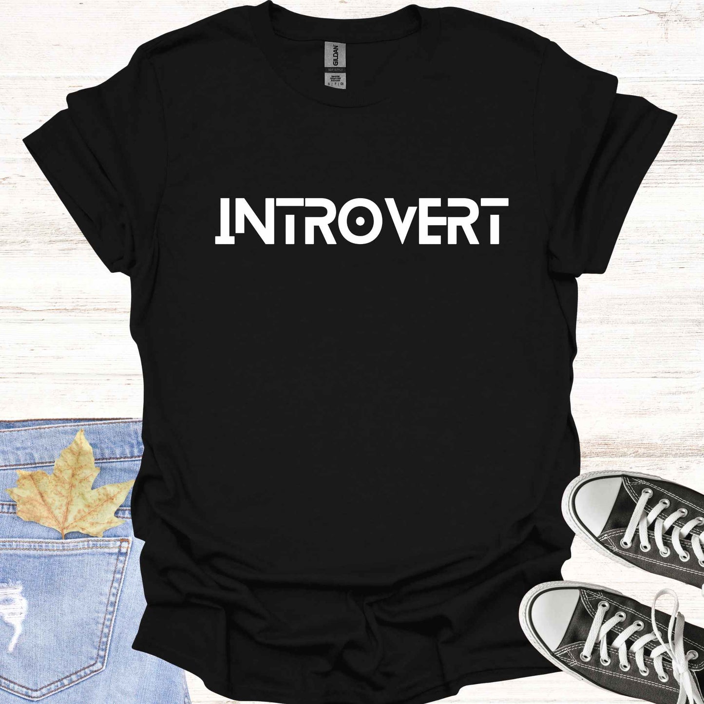 Black t-shirt featuring the word 'INTROVERT' in bold, striking lettering. This minimalist design celebrates introversion and resonates with individuals who value solitude, introspection, and quiet strength. Perfect for those who embrace their introverted nature with confidence and pride.