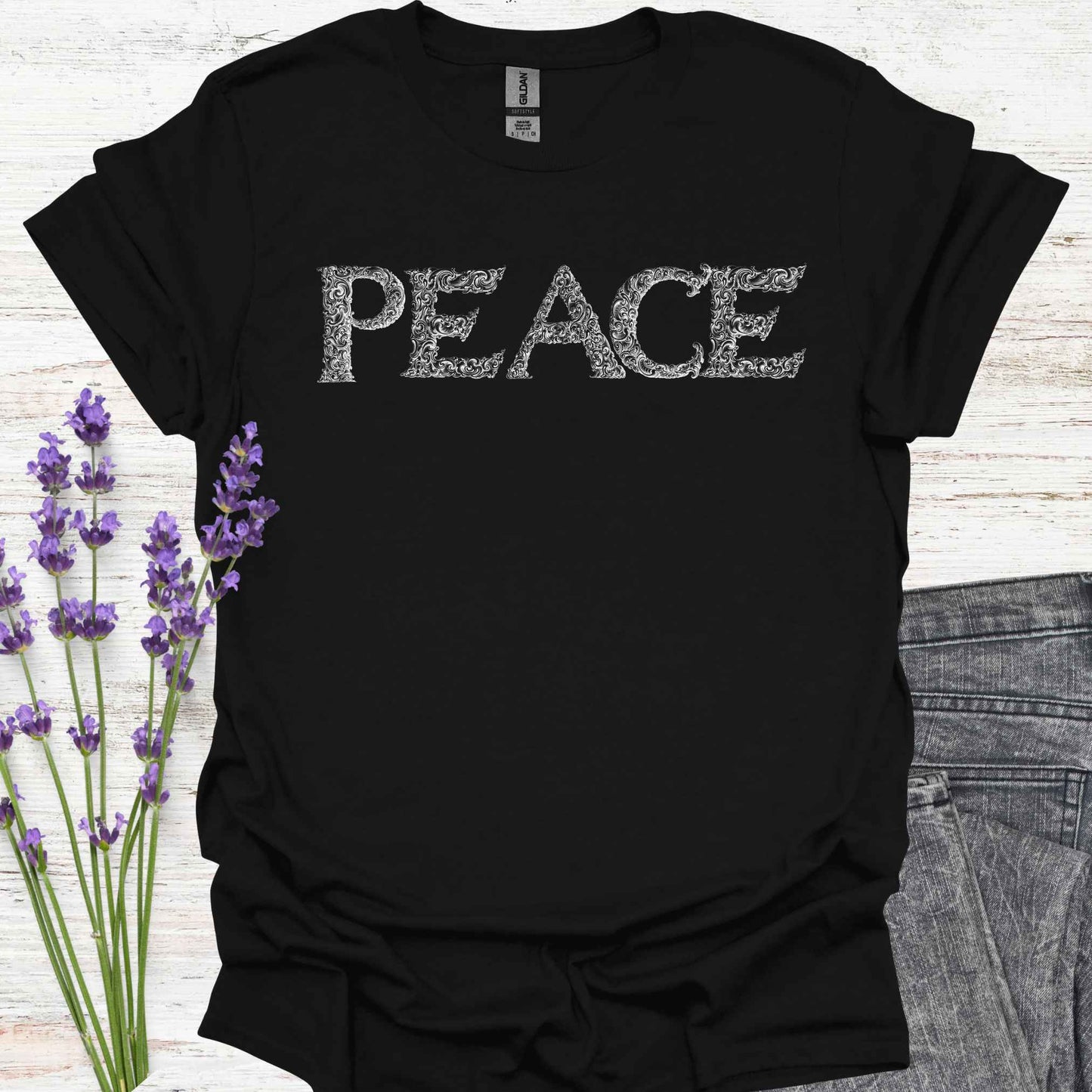 Black t-shirt with stylized lettering of the word 'Peace' in a unique, artistic font. This design embodies the concept of inner peace, harmony, and tranquility. Perfect for those who value calmness, mindfulness, and positivity. A reminder to cultivate peace within and spread it to the world.