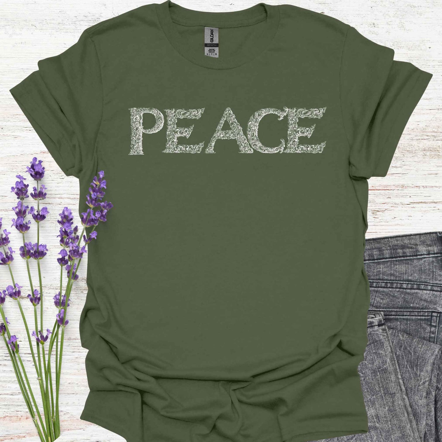 Military green t-shirt with stylized lettering of the word 'Peace' in a unique, artistic font. This design embodies the concept of inner peace, harmony, and tranquility. Perfect for those who value calmness, mindfulness, and positivity. A reminder to cultivate peace within and spread it to the world.
