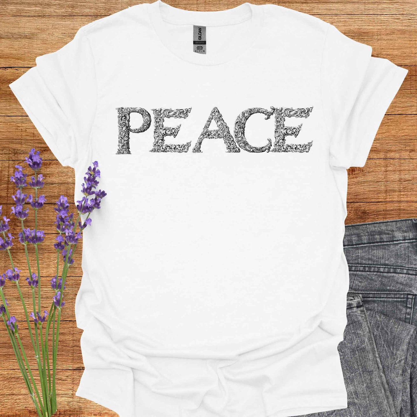 White t-shirt with stylized lettering of the word 'Peace' in a unique, artistic font. This design embodies the concept of inner peace, harmony, and tranquility. Perfect for those who value calmness, mindfulness, and positivity. A reminder to cultivate peace within and spread it to the world.
