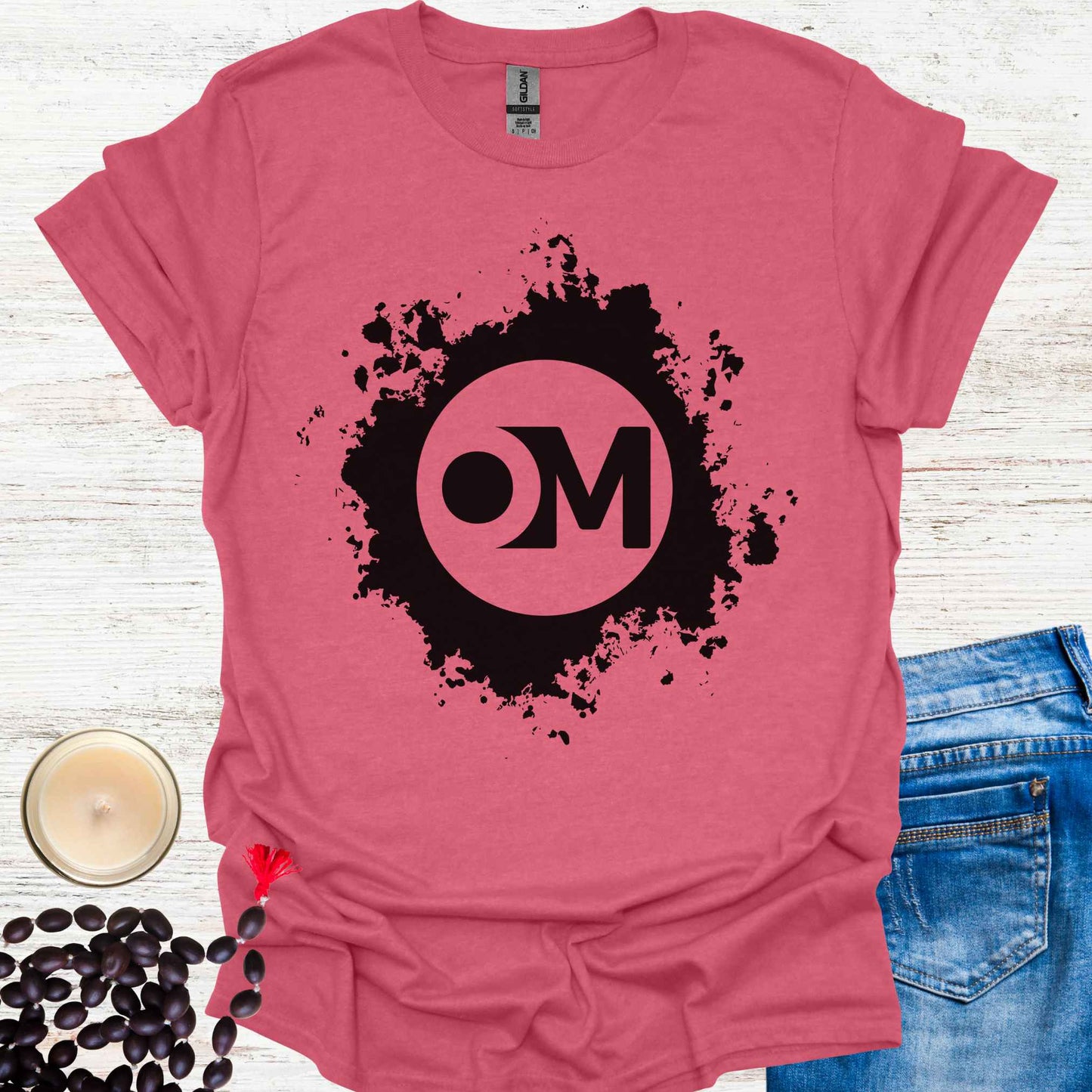 Red t-shirt featuring the word 'OM' at the center of a black abstract graphic. Om is a sacred sound and symbol representing universal vibration, interconnectedness, and divine energy. This design invites inner peace, mindfulness, and spiritual harmony, ideal for meditators and yogis.