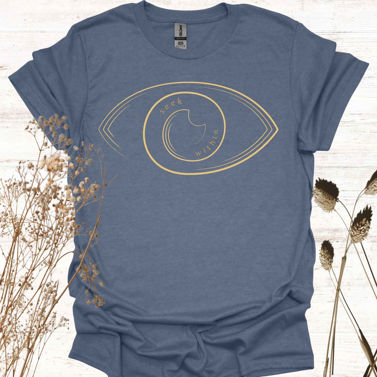 A blue t-shirt featuring a line graphic of an eye, with the phrase "Seek Within" placed inside. This design emphasizes the spiritual teaching that truth, peace, and self-realization can be found within one's own consciousness. Inspired by non-duality and self-reflection, it is ideal for spiritual seekers, meditators, and those drawn to introspection and inner wisdom.