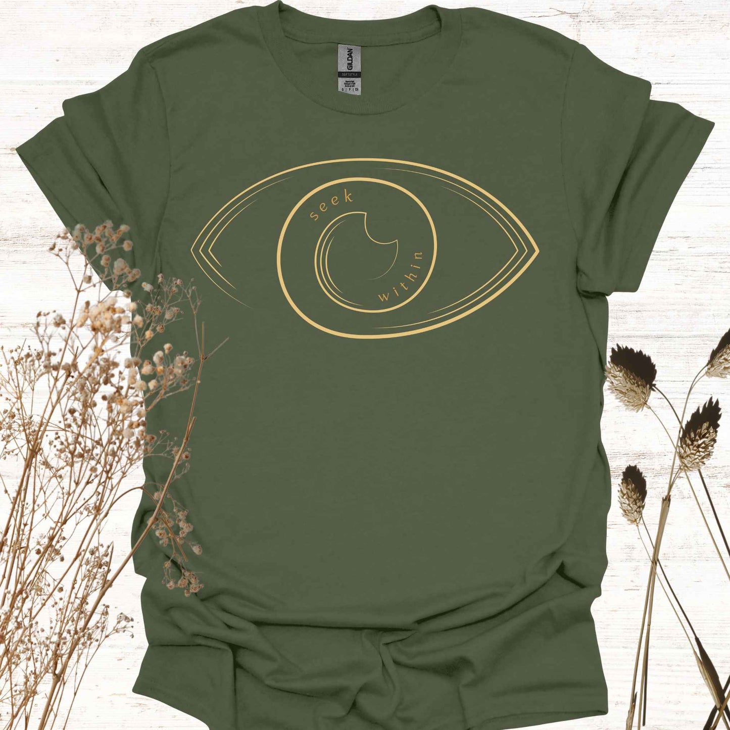A military green t-shirt featuring a line graphic of an eye, with the phrase "Seek Within" placed inside. This design emphasizes the spiritual teaching that truth, peace, and self-realization can be found within one's own consciousness. Inspired by non-duality and self-reflection, it is ideal for spiritual seekers, meditators, and those drawn to introspection and inner wisdom.