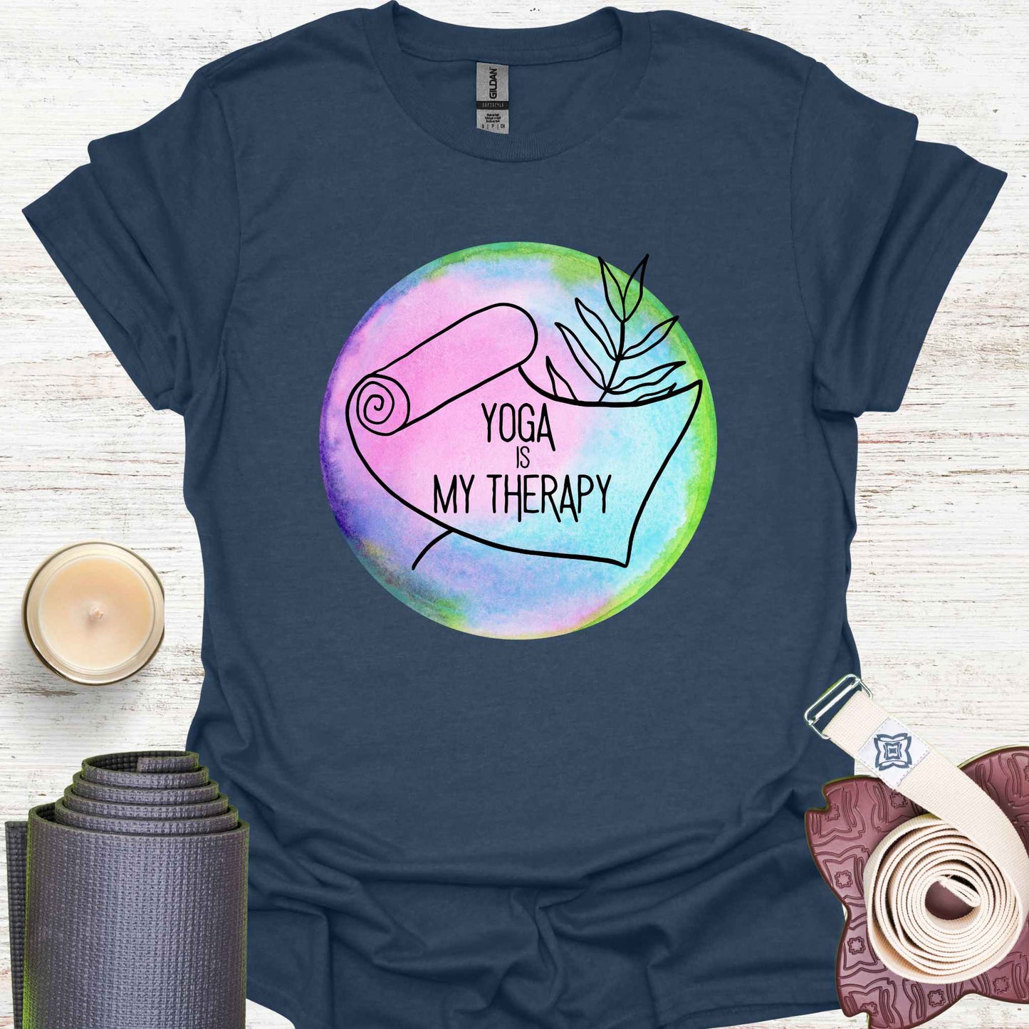 Navy blue t-shirt featuring a graphic of a yoga mat placed on a round, colorful watercolour background, with the phrase 'Yoga is My Therapy.' This design highlights the therapeutic power of yoga, promoting physical and mental well-being, relaxation, and mindfulness. Perfect for those who turn to yoga as a form of self-care, stress relief, and personal healing.