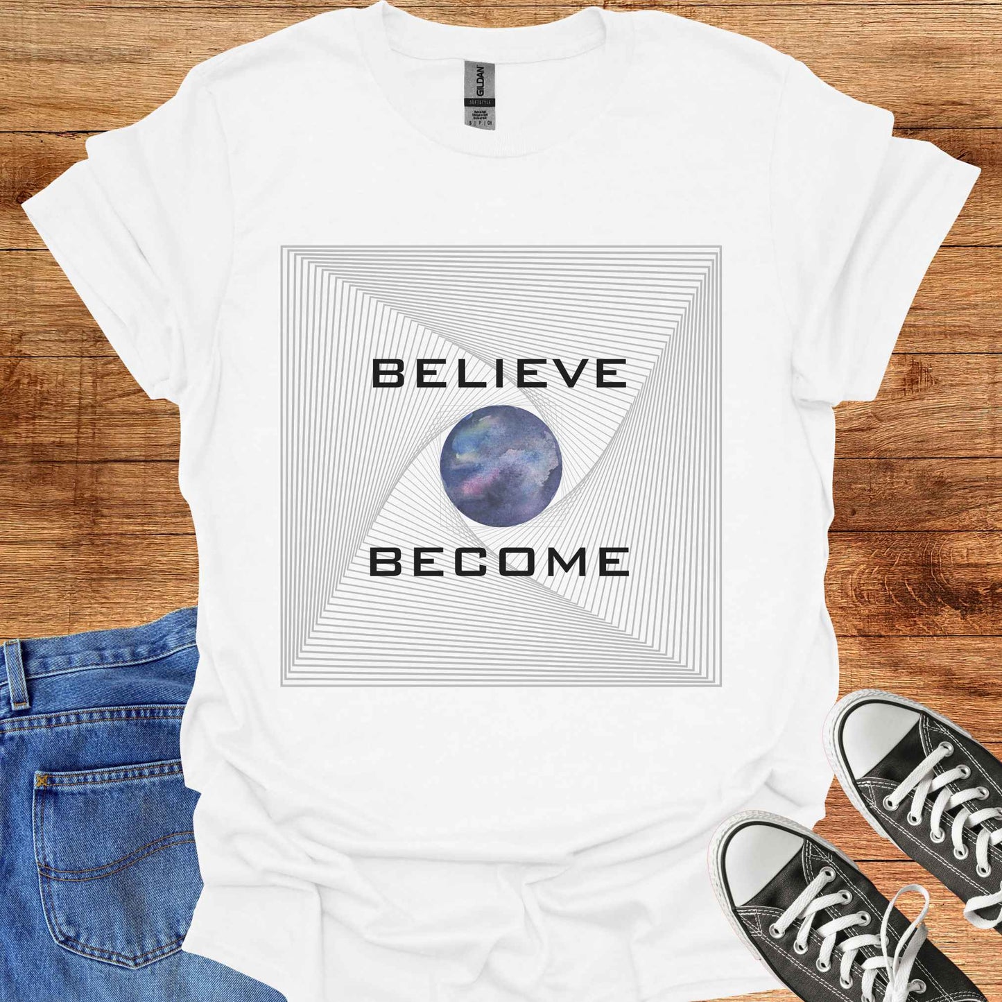 White t-shirt featuring an abstract fractal design with a watercolor Earth graphic at the center, accompanied by the phrase 'Believe, Become.' This design symbolizes personal growth, transformation, and the connection between belief and action. The fractal pattern reflects the interconnectedness of all things, while the Earth graphic evokes a sense of global unity and harmony.