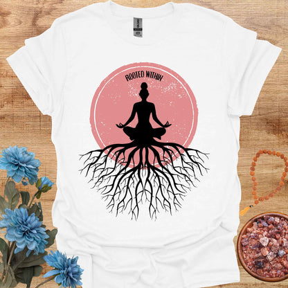 White t-shirt featuring a graphic of deep tree roots extending downward, with the form of a meditating person sitting on top, suggesting that the roots belong to the meditator. This design symbolizes the yogic teaching of keeping awareness within, grounding oneself in inner peace, and embodying wisdom through meditation and spiritual practice